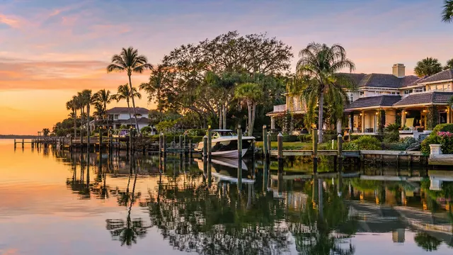 Sunset on the St. Lucie River, waterfront homes along the bank.