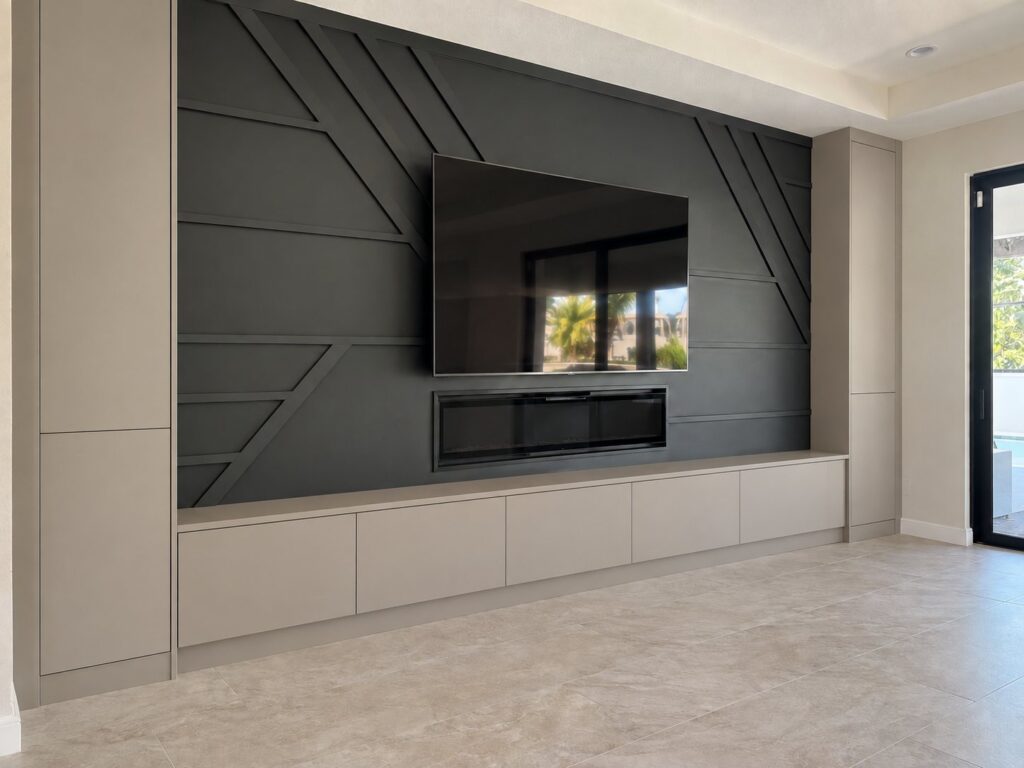 Charcoal geometric accent wall with a TV, fireplace and built-ins