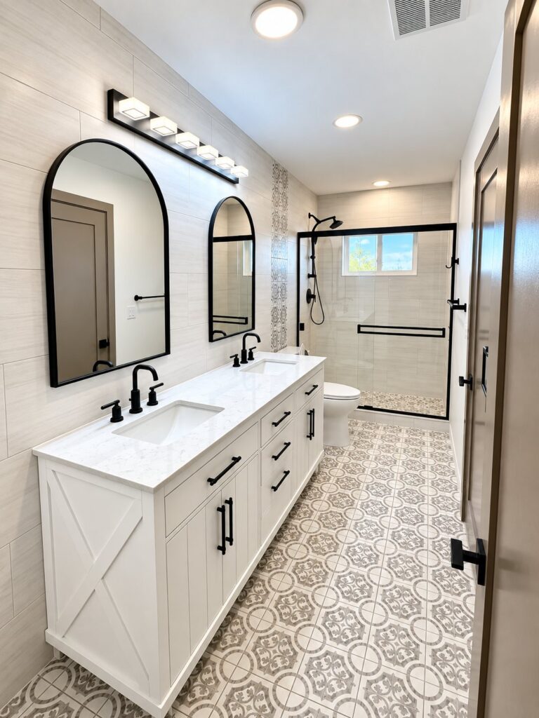 Bathroom with a white double vanity, arched mirrors and patterned floor tile