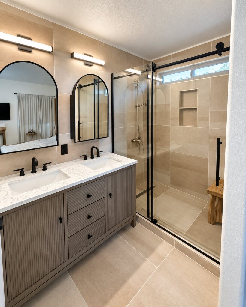 Bathroom with arched mirrors, a ribbed wood vanity and a sliding glass shower