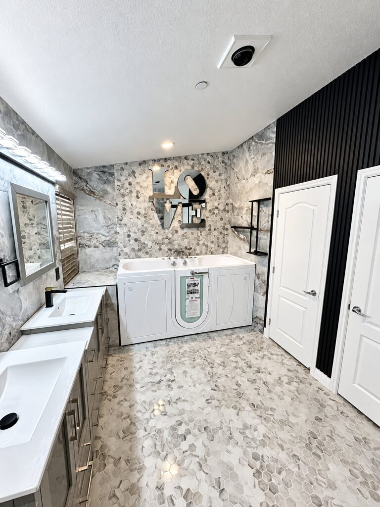 Bathroom with a walk-in tub, mosaic floor and black slat wall