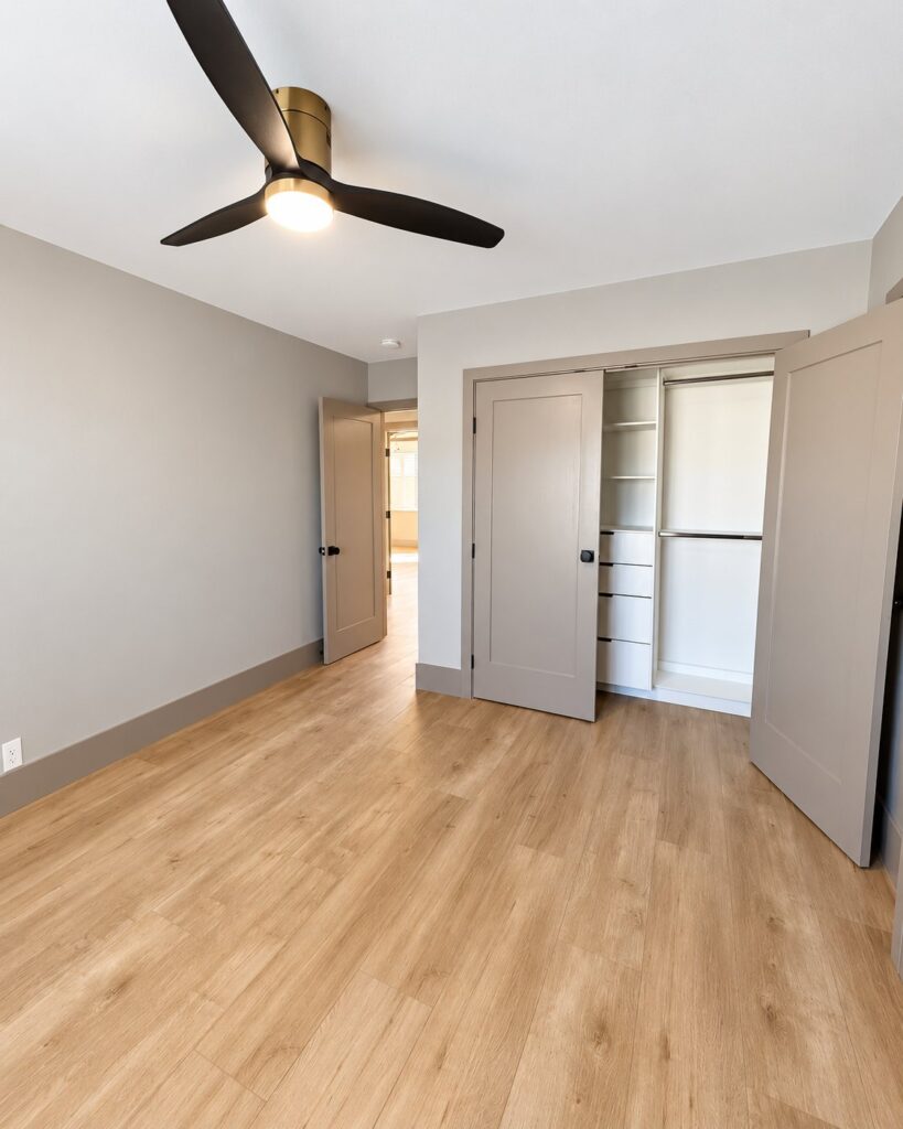 Bedroom with new greige doors and a closet with built-in shelves