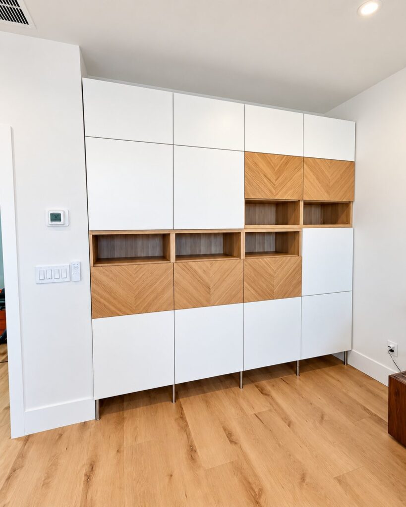 Built-in wall cabinet in white and herringbone wood