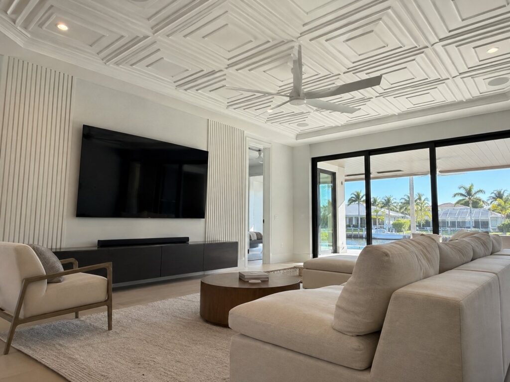 Living room with a white coffered ceiling and a wood slat wall