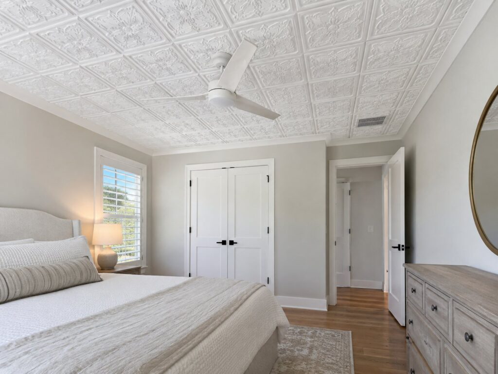 Bedroom with an embossed white tin-look tile ceiling