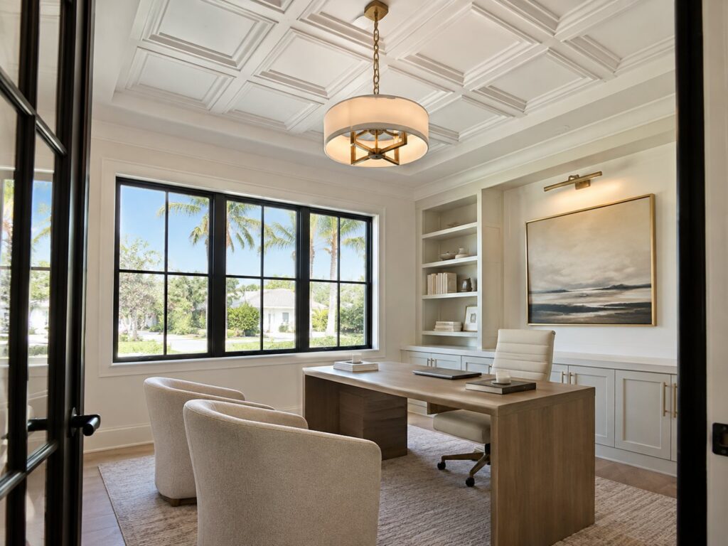 Home office with a white coffered ceiling and pendant light