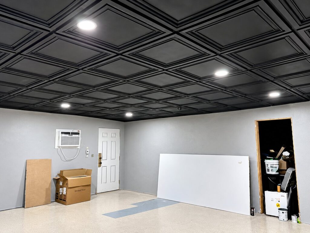 Black coffered drop ceiling with recessed lights going in
