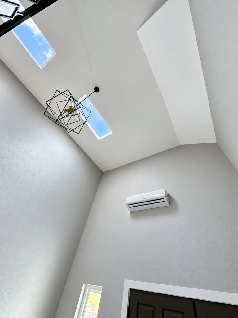 Vaulted ceiling with a skylight and a geometric pendant