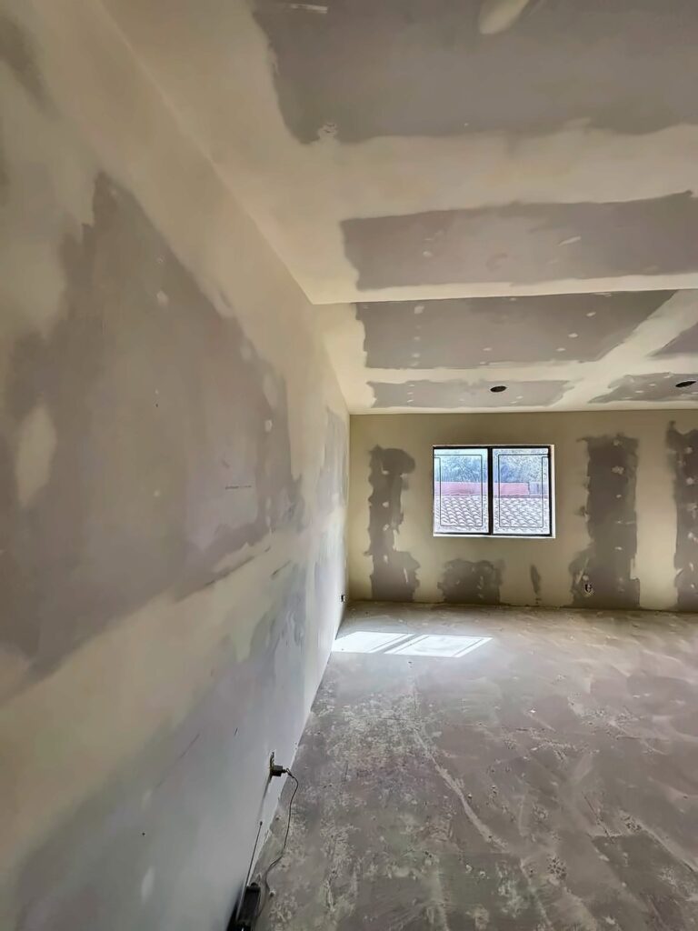Room with drywall taped and mudded