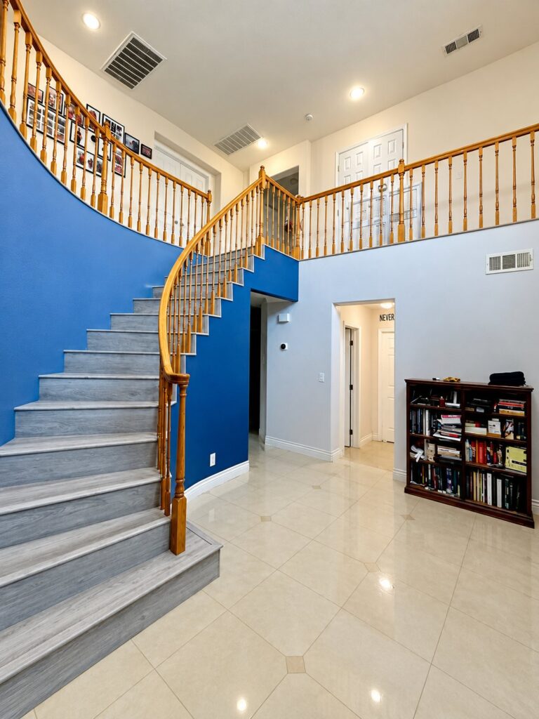 Two-story stair hall with a finished curved wall