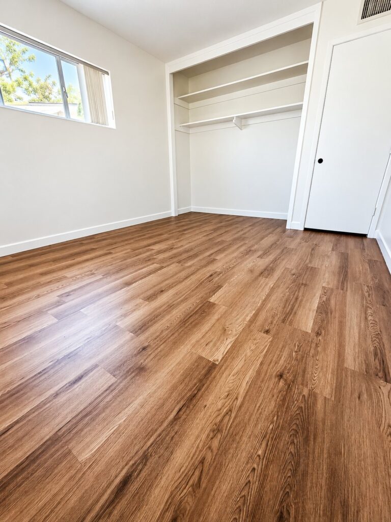 Bedroom with warm wood plank flooring
