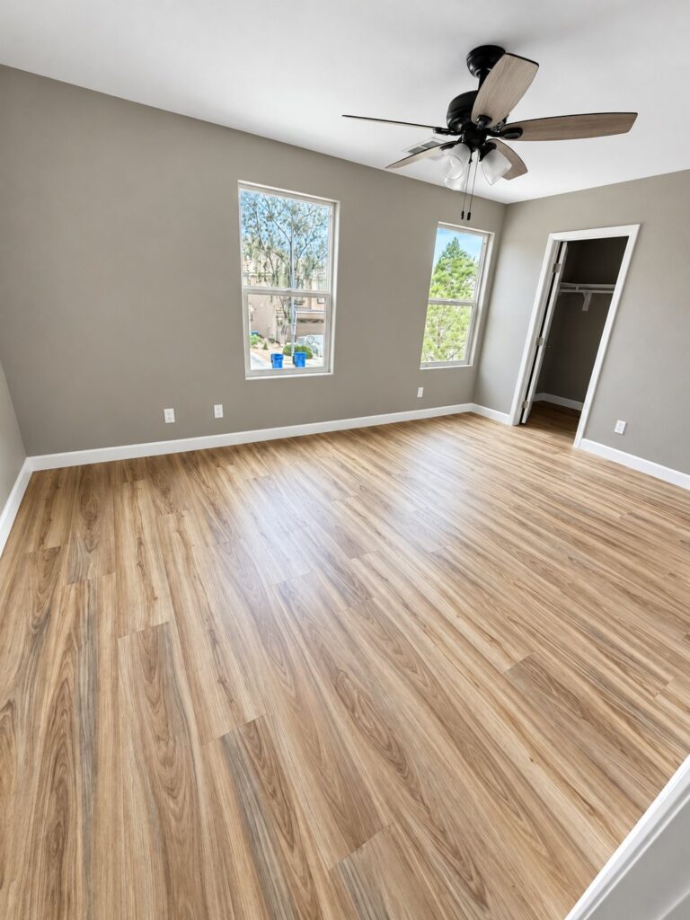 Bedroom with light plank flooring and a ceiling fan