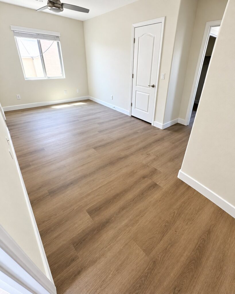Room with warm brown plank flooring
