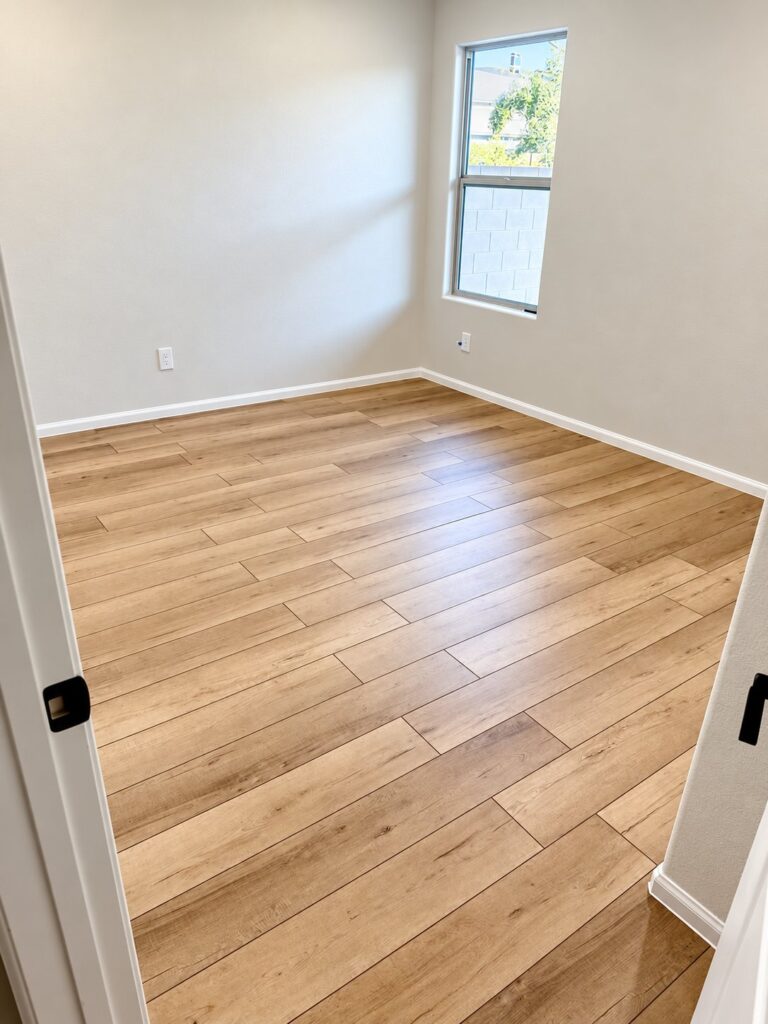 Room with light oak plank flooring laid on the diagonal
