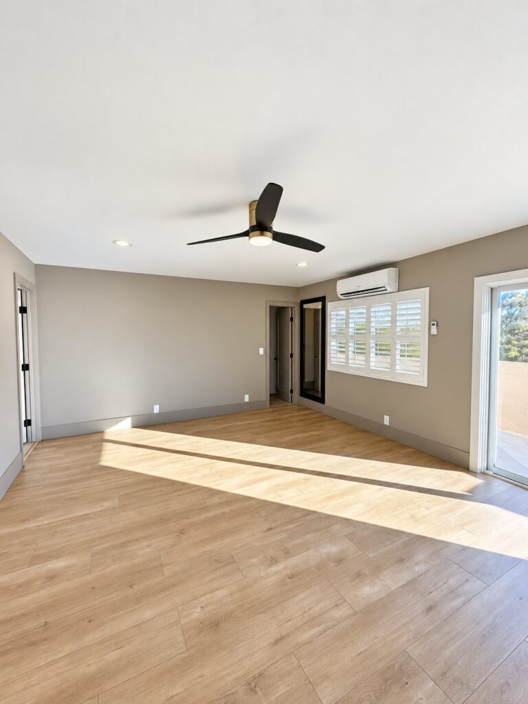 Living room with light oak flooring and a mini-split