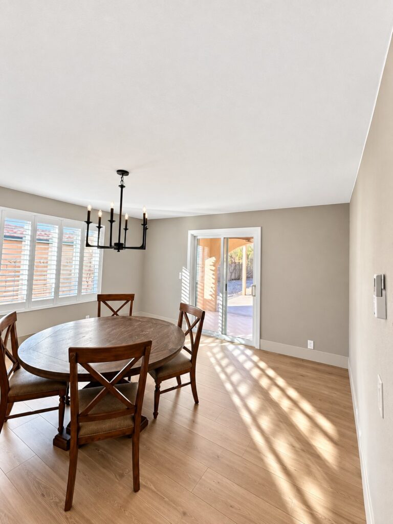 Dining room with light oak flooring and an iron chandelier