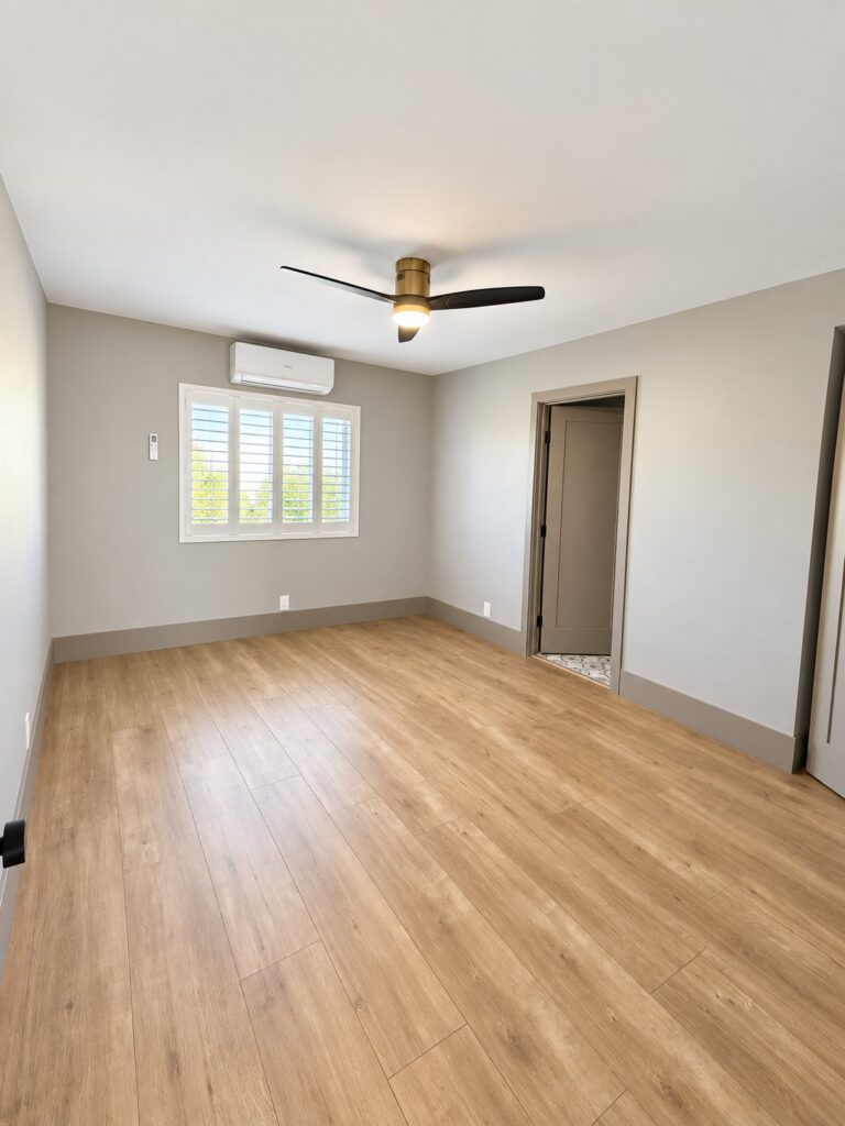 Bedroom with light oak flooring and a mini-split