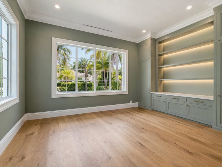 Study with lit built-in shelving and oak floors