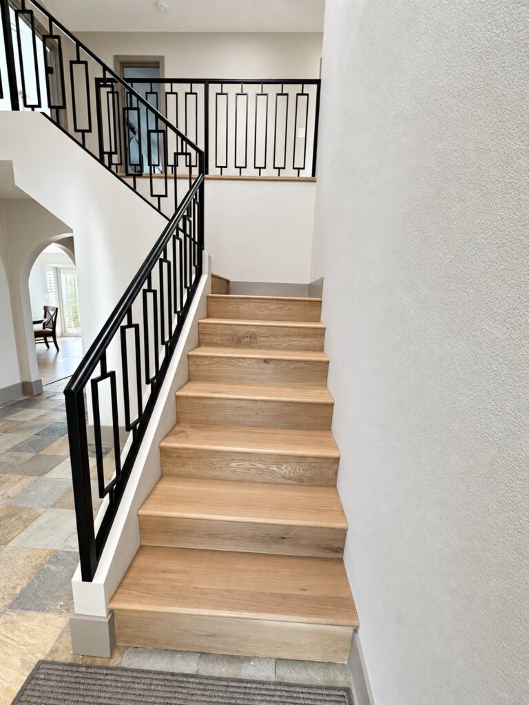 Staircase with oak treads and a black geometric railing