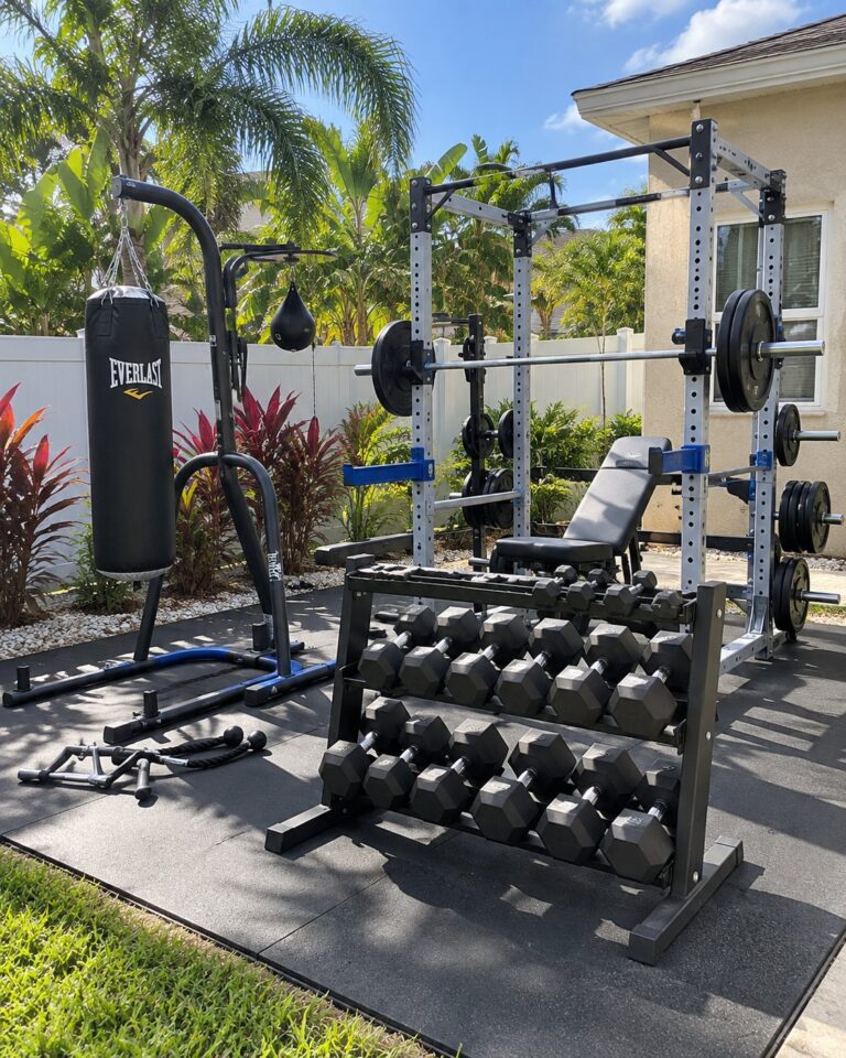 Backyard home gym with a power rack and dumbbells