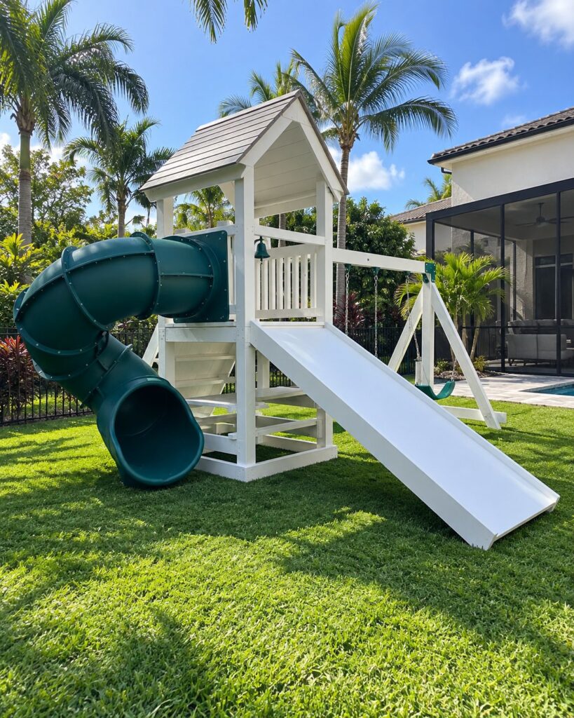 White play set with a tube slide and swings