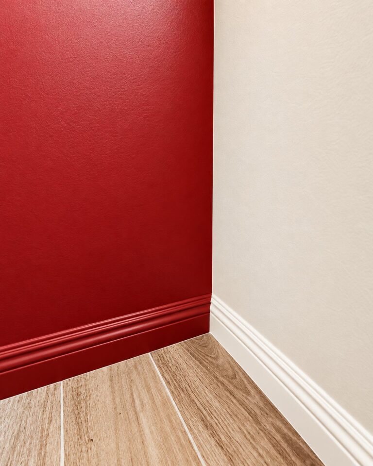 Red accent wall with a crisp line at the baseboard