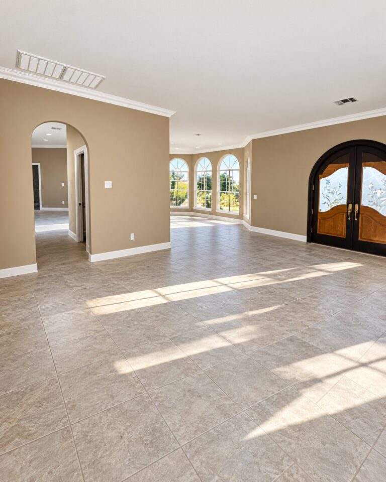Great room in warm beige with arched windows