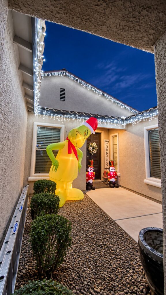 Holiday lights installed along a courtyard roofline