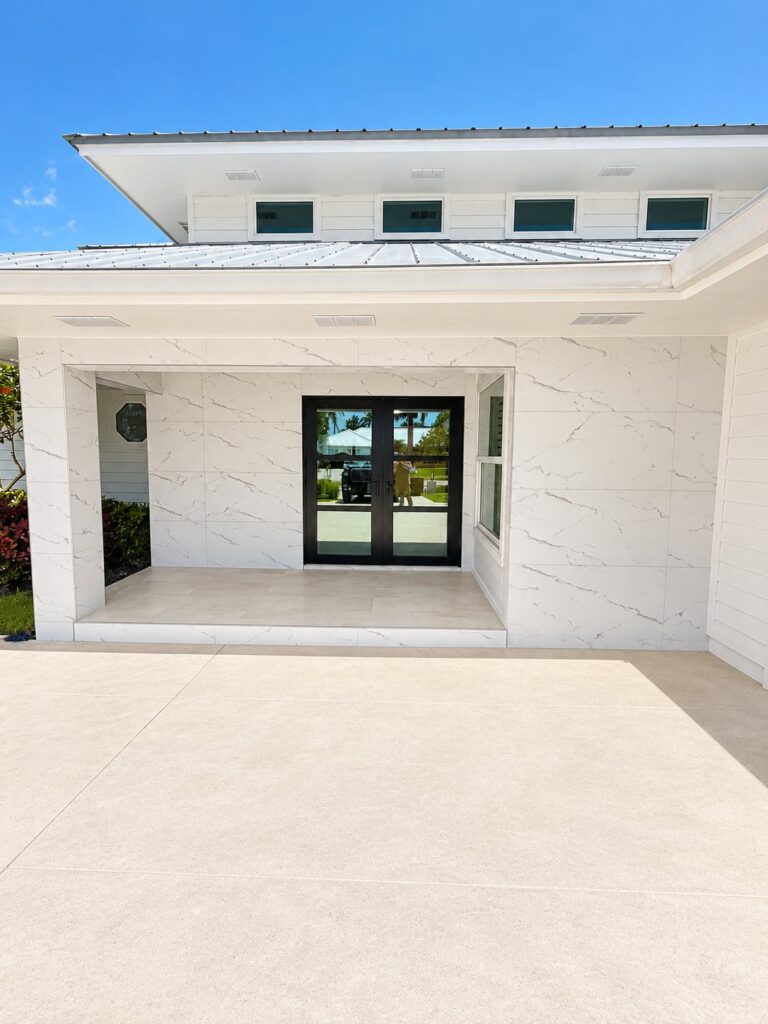 Front porch walls clad in large white marble-look porcelain
