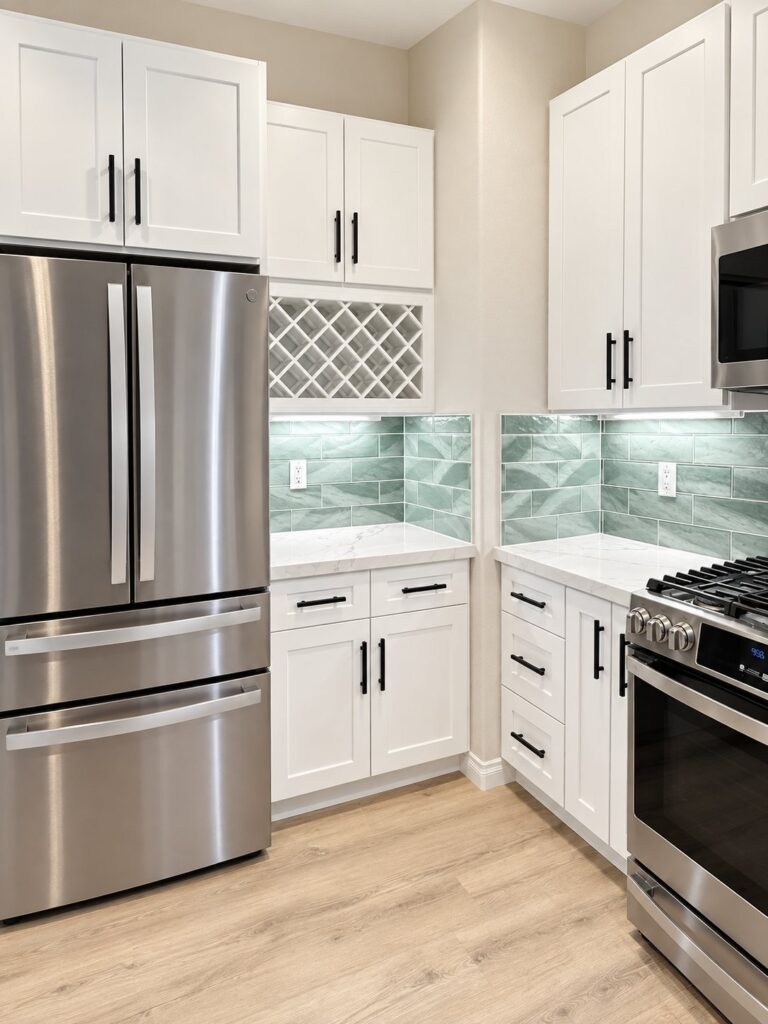 White kitchen with a sage glass tile backsplash