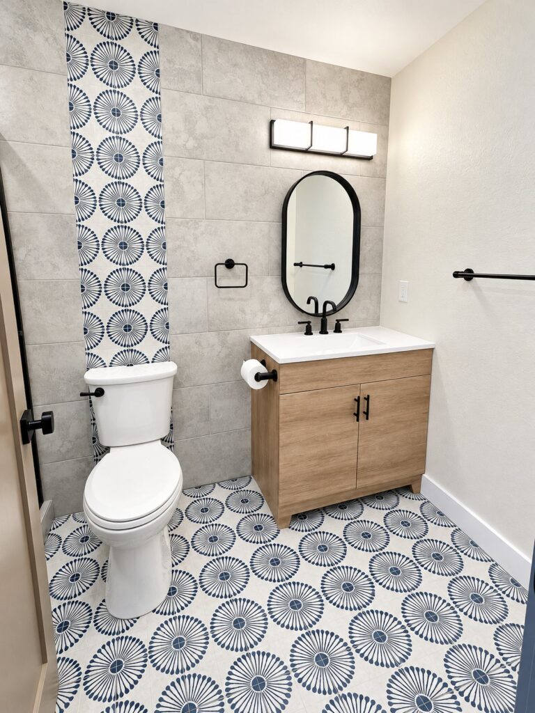 Bathroom with a blue patterned porcelain floor and an accent stripe