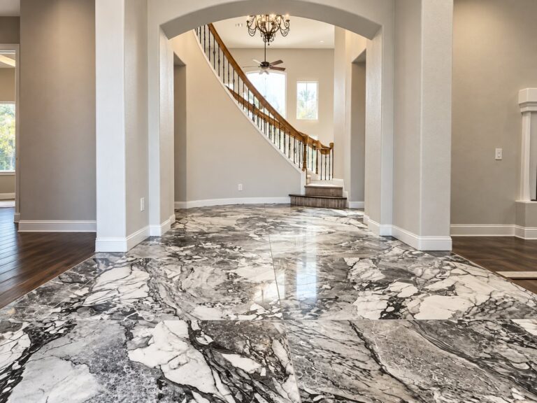Entry hall with large polished marble-look floor tile