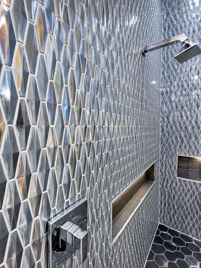 Shower wall in iridescent elongated hexagon mosaic