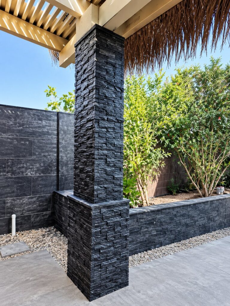 Outdoor column and planter clad in black stacked stone