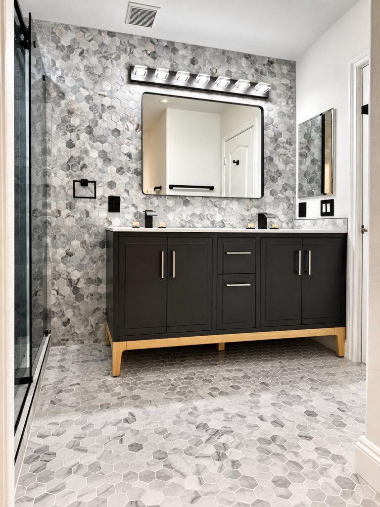 Bathroom with a marble hexagon mosaic floor and wall and a black vanity