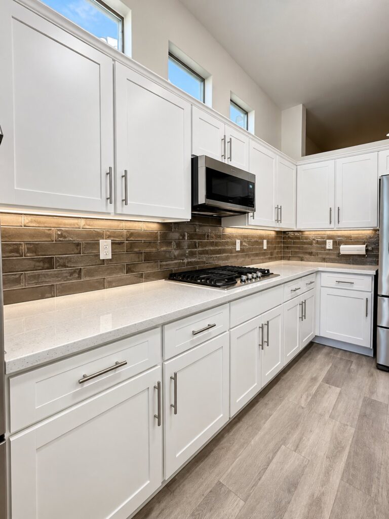 White kitchen with a brown glass plank backsplash